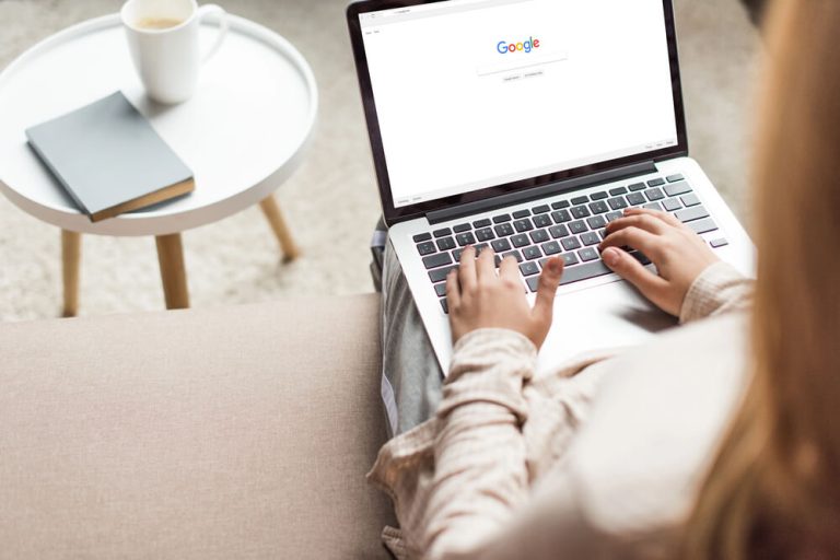 How Small Businesses Can Build a Strong Online Presence woman searching on google siting on floor view from above