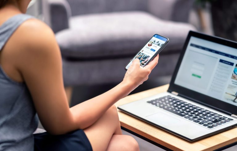 Making The Best Impression Online, Wherever It Happens Woman sitting on sofa researching business online presence on laptop and mobile