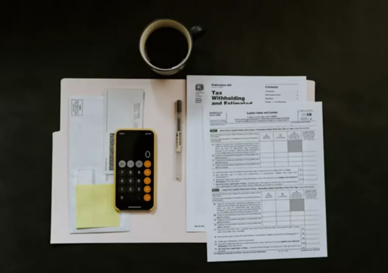 Why Business Tax Planning Should Happen All Year Busy Desk with caluator and tax paperwork