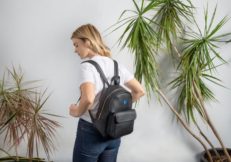 Woman wearing black leather backpack