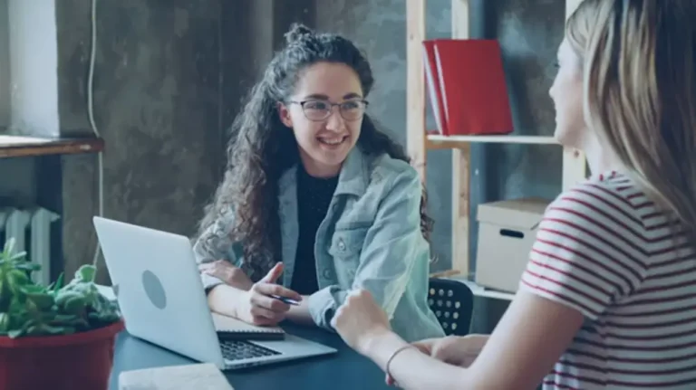 Mastering Client Connection in a Digital World Women chatting by a laptop