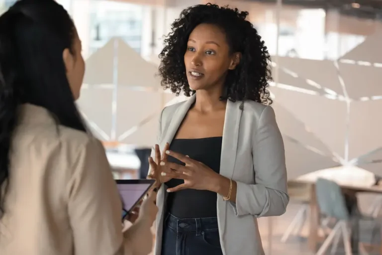 Who Challenges the Woman Everyone Turns To? Woman Having Mentoring Conversation in Office