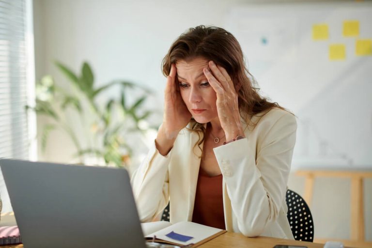 Why We Need to Rethink Resilience: Being Able to Carry It Does Not Mean You Should Have To Business Woman Looking Overwhelmed with Workload