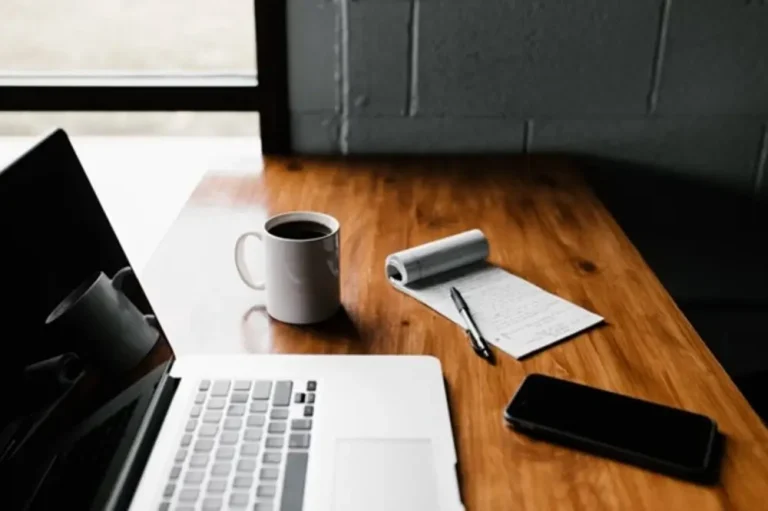Your Resume as a Growth Mindset Tool Desk with Laptop and Coffee Mug